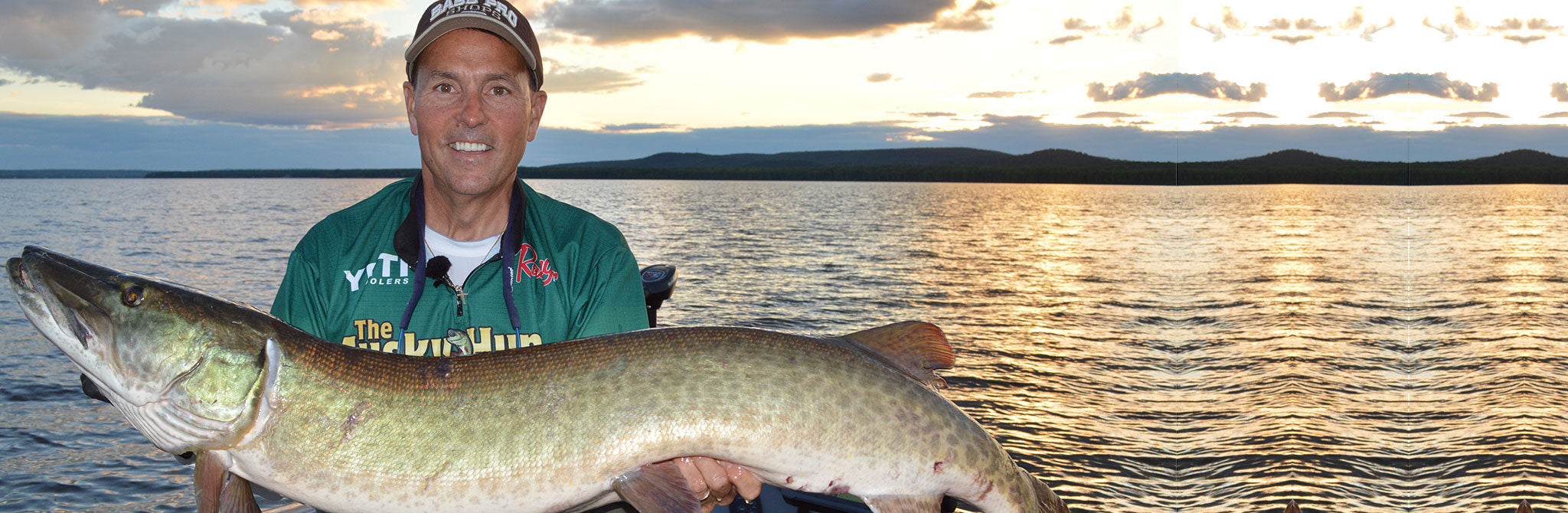Giant musky being held by professional Muskie fisherman while using Dubro fishing accessories