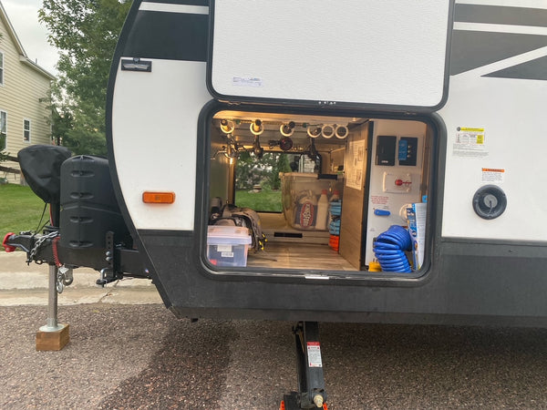 Dubro fishing rod rack mounted in rv camper storage