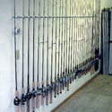A wall full of high quality fishing rods stored vertically in Dubro's custom fishing rod racks called Trac-A-Rods.   